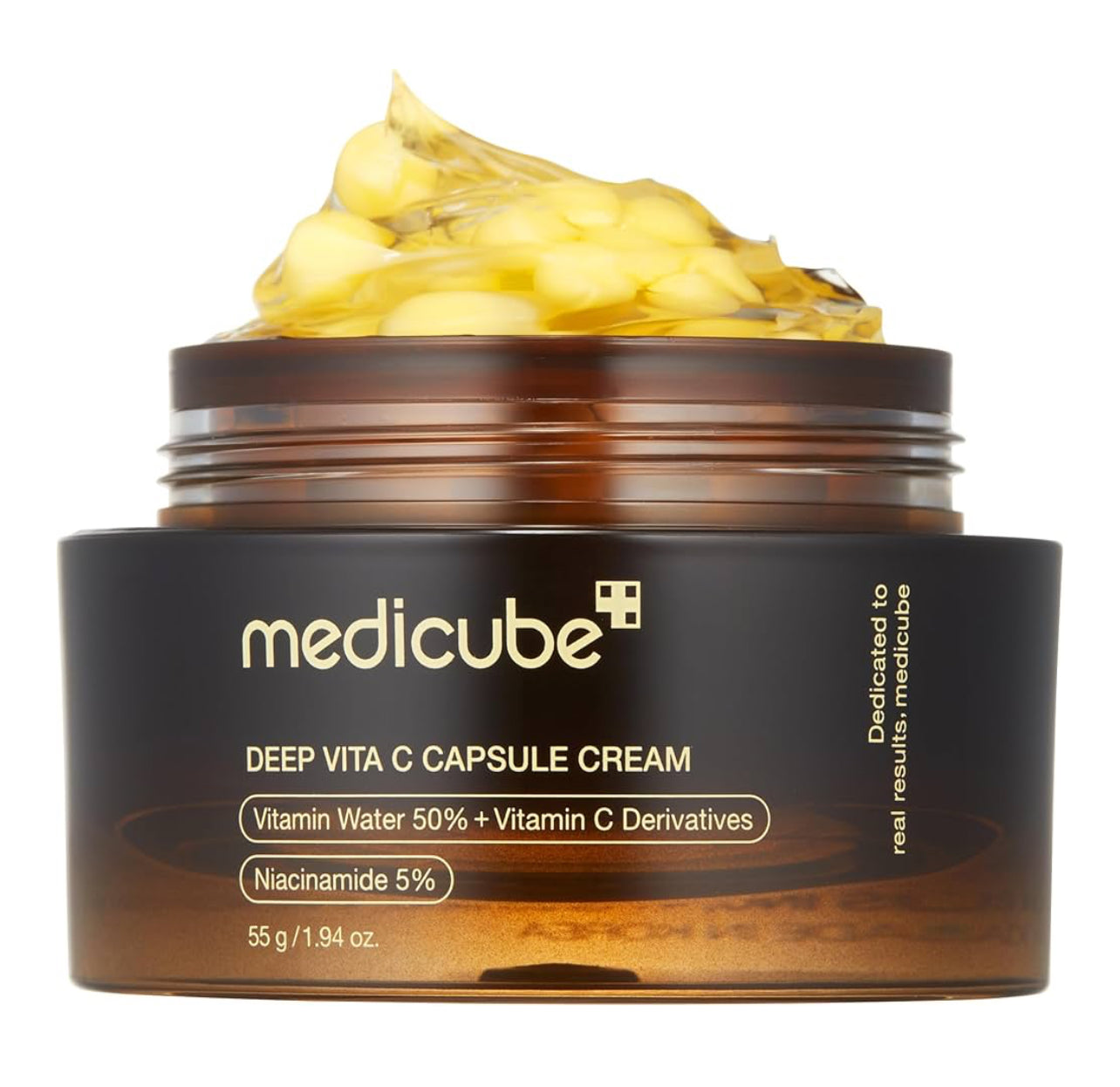 Open jar of Medicube Deep Vita C Capsule Cream showing yellow vitamin C capsules in transparent gel texture